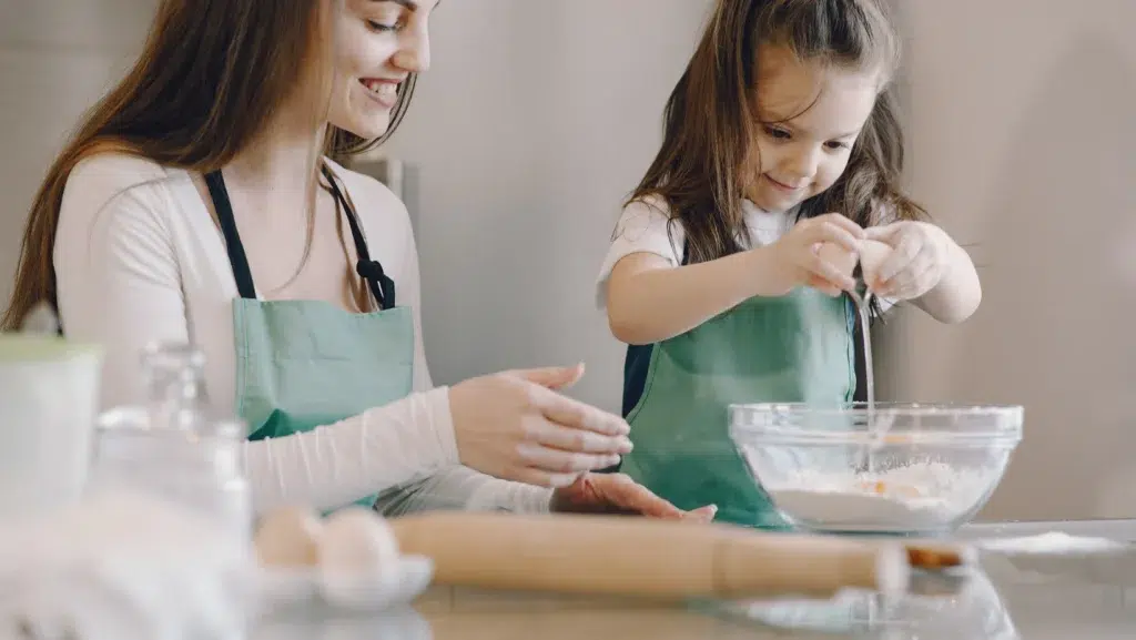 Mom and Child Baking With Egg and Flour