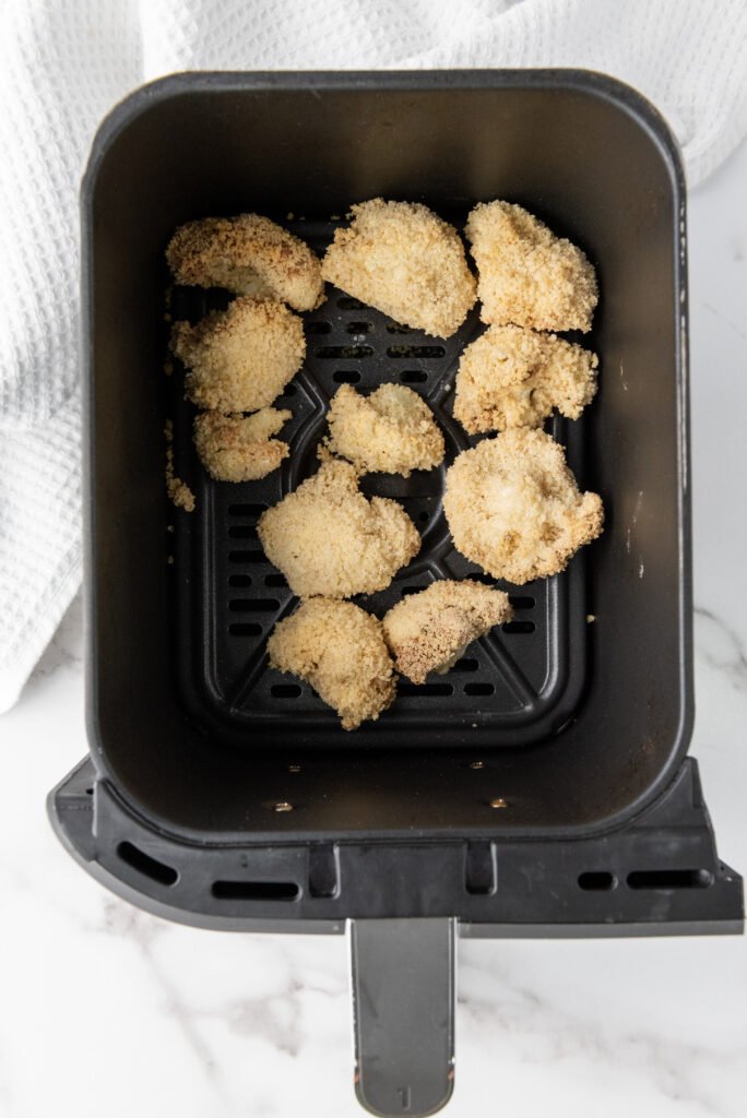 Cook the Cauliflower Wings in the Air Fryer 🍲🔥-The Perfect Vegan Treat! - A plate of golden-brown teriyaki cauliflower wings with a glossy, caramelized glaze.