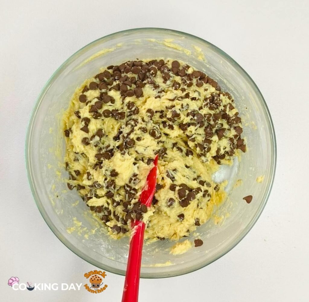 A bowl of combine dry and wet Ingredients with chocolate chips added Chocolate Chip Muffins Recipe