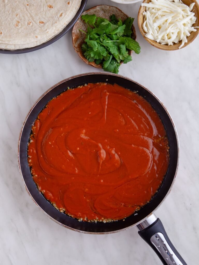 Pour in the enchilada sauce