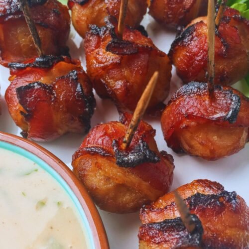 Crispy bacon-wrapped water chestnuts served with creamy spicy mustard dip