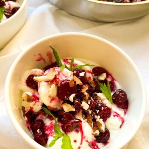 Classic Cherries Jubilee served warm over vanilla ice cream with glossy cherry sauce