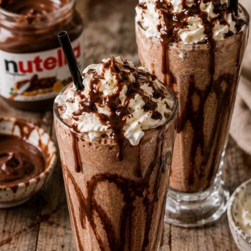 Creamy Nutella milkshake made with vanilla ice cream, Nutella, milk, and whipped cream