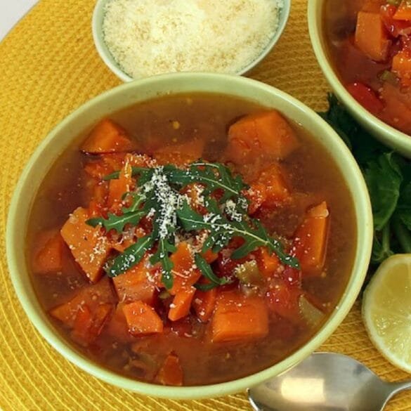 Sweet potato vegetable soup with carrots, celery, tomatoes, spinach, and Parmesan cheese