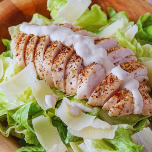 Chicken Caesar Salad with roasted chicken, romaine lettuce, Parmesan cheese, and creamy homemade Caesar dressing
